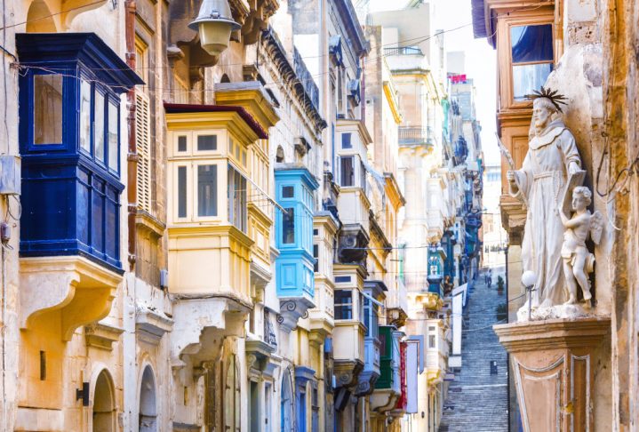 Typical narrow streets with colorful balconies in Valletta , Malta