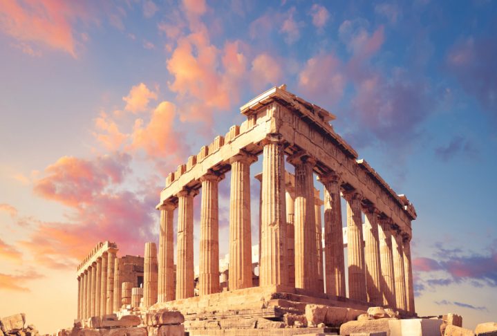 Parthenon temple on a sunset with pink and purple clouds. Acropolis in Athens, Greece