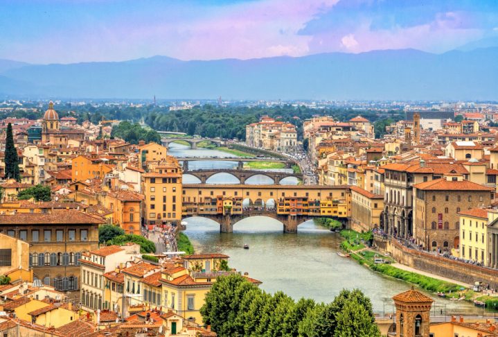 Aerial view of medieval stone bridge Ponte Vecchio over Arno river in Florence, Tuscany, Italy. Florence cityscape. Florence architecture and landmark.