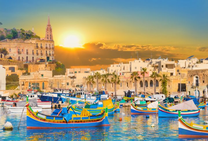 Marsaxlokk village harbor of Malta, illuminate by sunset light