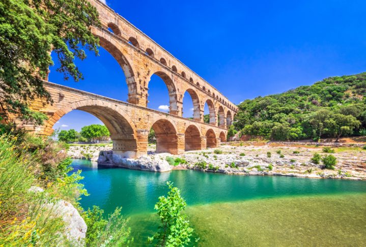 Pont du Gard three-tiered aqueduct was built in Roman times on the river Gardon. Provence summer day.