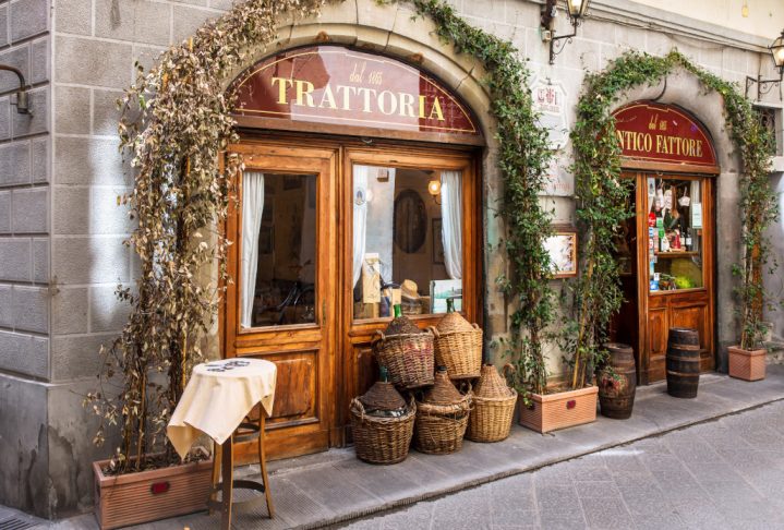 FLORENCE, ITALY - APRIL 08, 2018: Traditional trattoria on narrow street in Florence, Tuscany Italy