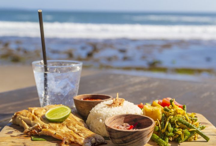 Fresh lunch in a beautiful location with sea views.Table with delicious food near the sea with horizon.