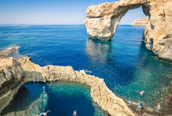 The world famous Azure Window in Gozo island - Mediterranean nature wonder in the beautiful Malta - Unrecognizable touristic scuba divers