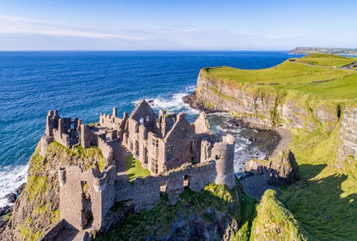 JKGF8C Ruins of medieval Dunluce Castle, cliffs, bays and peninsulas. Northern coast of County Antrim, Northern Ireland, UK.  Aerial view.